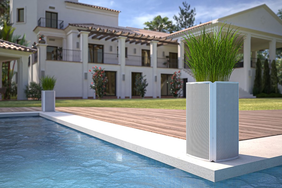 A Coastal Source’s Razor Speaker used as a planter on the side of a pool.